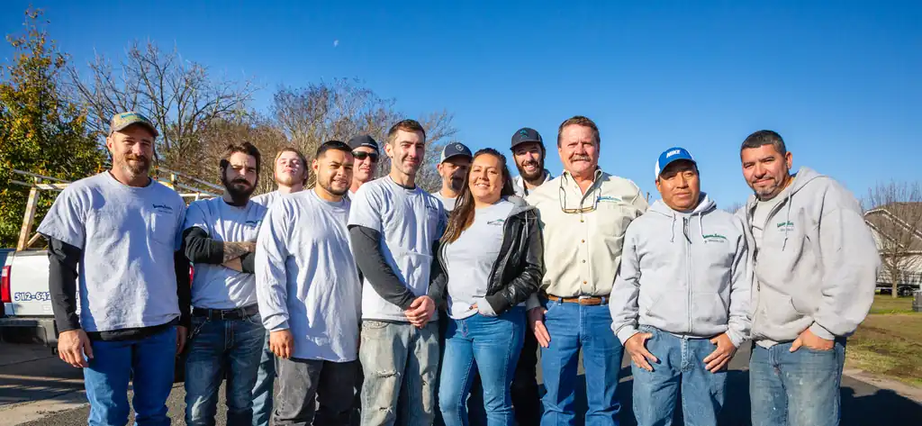 Full Lightning Electrical crew outdoors in branded shirts with a service truck behind them