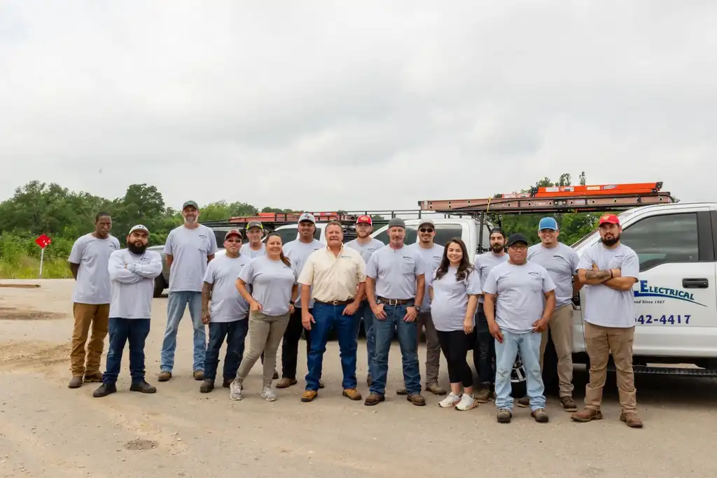 The Lightning Electrical crew in front of a branded service truck